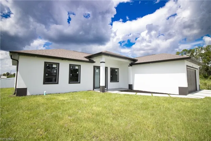 Back of property featuring a yard and a patio area