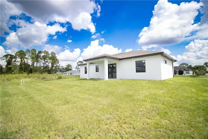 Back of property with a yard