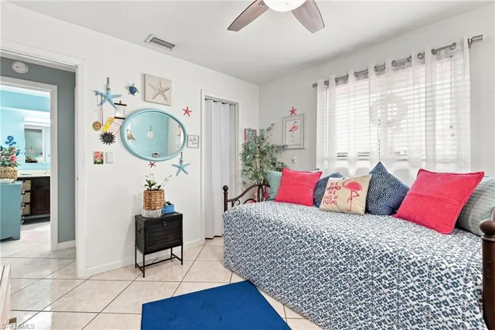 Recessed lighting with a ceiling fan, tile flooring, window with blinds, and white interior doors