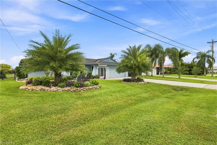 Established landscaping featuring multiple palm trees