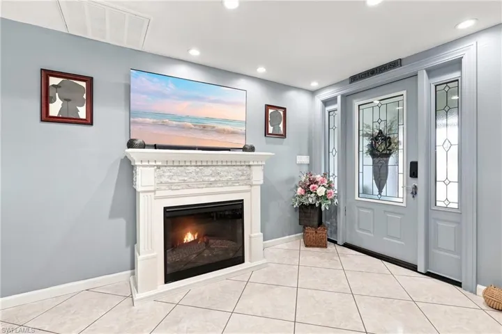 Recessed lighting illuminates the tiled entry