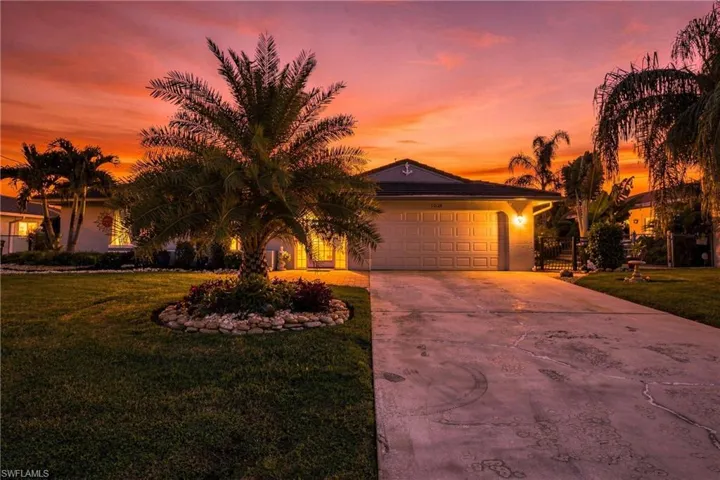 Single-story residence with an attached garage, concrete driveway, and front lawn