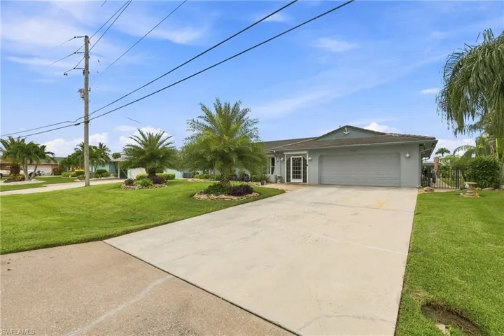Expansive concrete driveway and walkway leading to the home