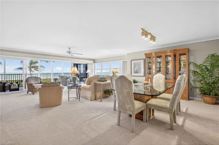 Spacious living area featuring expansive glass sliding doors, providing abundant natural light and views of the ocean