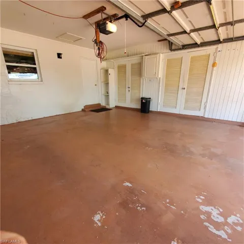 Garage with french doors and a garage door opener