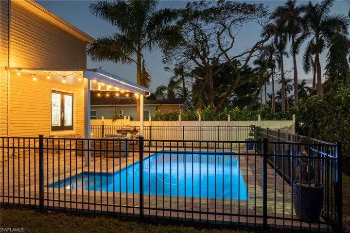 View of swimming pool featuring a patio, fence, a fenced in pool, and french doors
