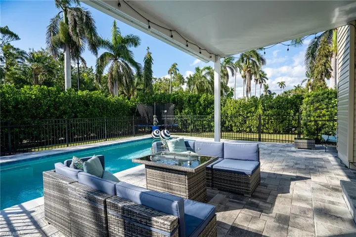 View of swimming pool featuring outdoor lounge area, a patio area, and a fenced backyard