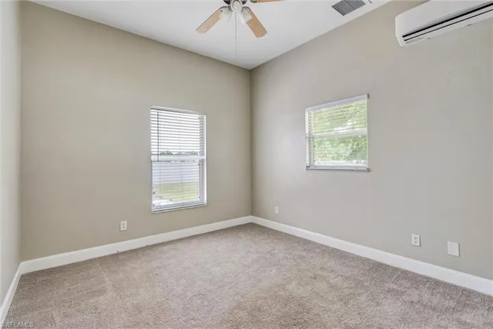 Spacious room featuring neutral carpeting and light-toned walls