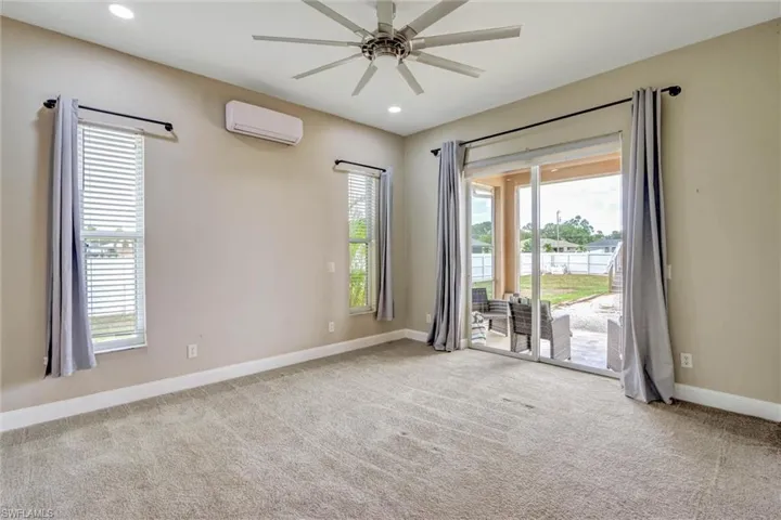 Carpeted room with recessed lighting and a ceiling fan
