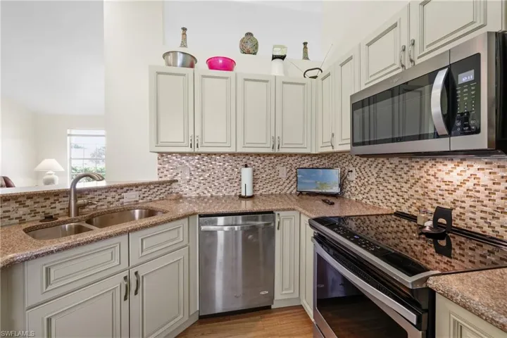 Newer Wood Cabinets + Stone Counter & Tile Backsplash