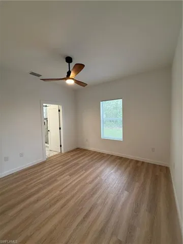 Empty room with light wood-type flooring and ceiling fan
