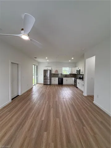 Unfurnished living room with light wood-type flooring, plenty of natural light, ceiling fan, and recessed lighting