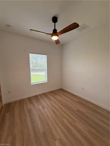 Unfurnished room with light wood-style flooring and ceiling fan