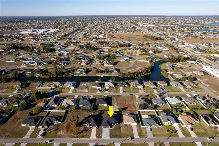Located in desirable NORTHERN SW Cape Coral, offers NO FLOOD INSURANCE, durable METAL ROOF, 3-CAR GARAGE & CITY WATER & SEWER!