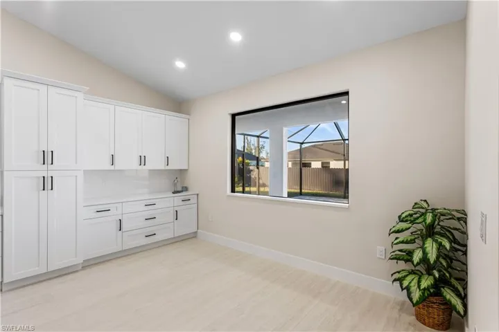 BUILT-IN CUSTOM WHITE CABINETRY provides ADDED STORAGE & CLEAN, UPSCALE LOOK.