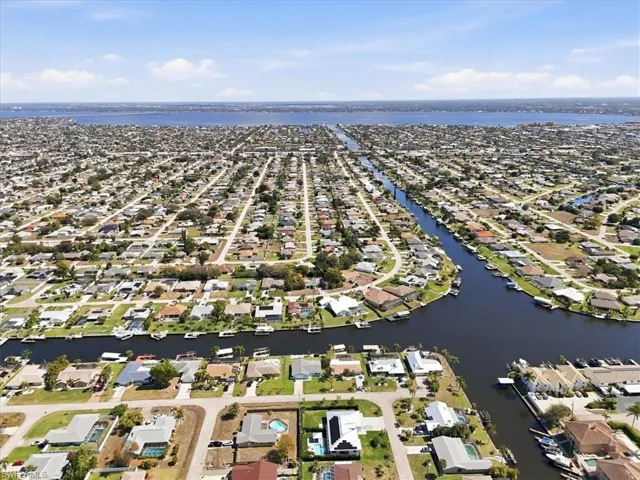 Aerial perspective of suburban area featuring a large body of water