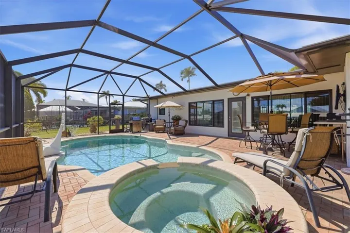 Combined pool / hot tub with outdoor dining area, and a patio area