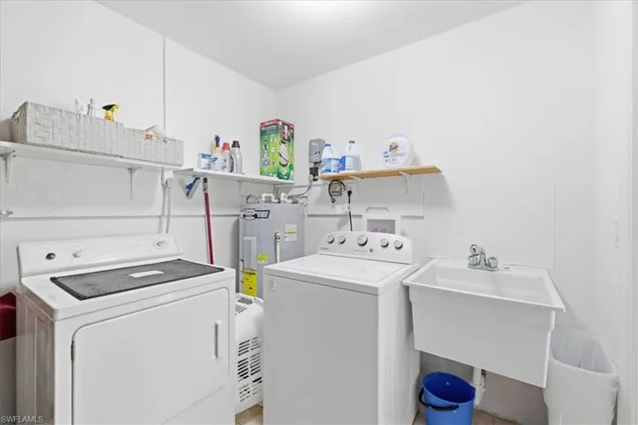 Laundry area featuring washer and clothes dryer and water heater