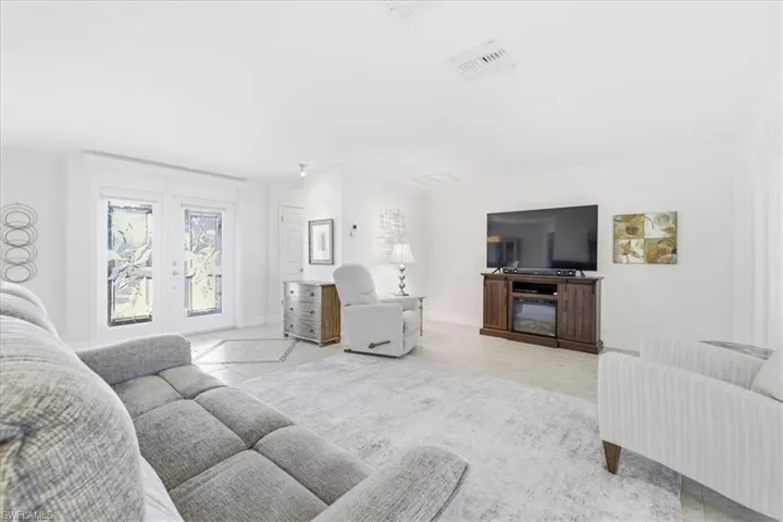 Living room featuring french doors and light tile patterned floors