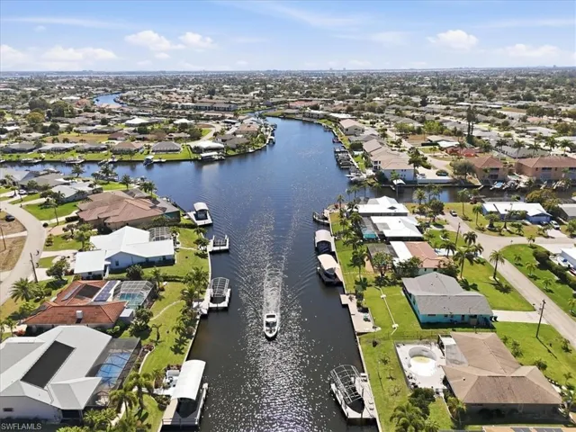 Aerial view of property's location with nearby suburban area and a nearby body of water