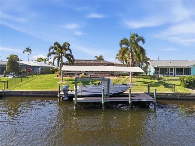 Dock area with boat lift and a water view
