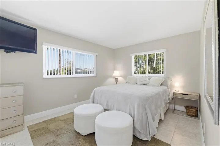 Bedroom featuring light tile patterned floors and baseboards