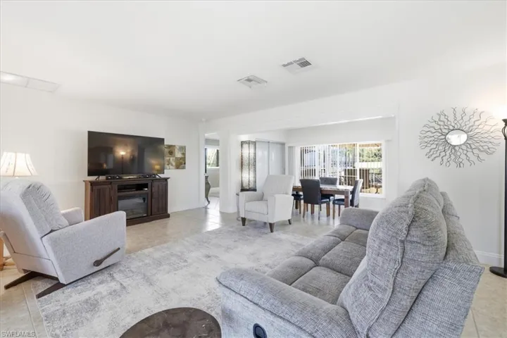 Living area with light tile patterned floors and baseboards