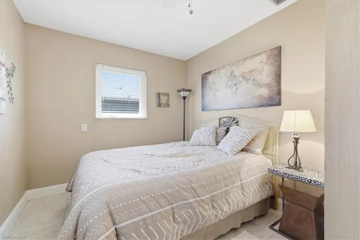 Bedroom with a ceiling fan and light tile patterned floors
