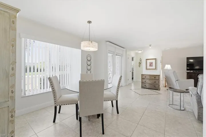 Dining room with light tile patterned flooring and baseboards