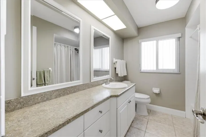Bathroom with vanity and light tile patterned flooring