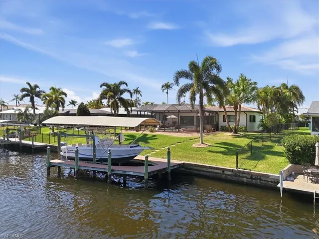 Dock featuring a water view, boat lift,