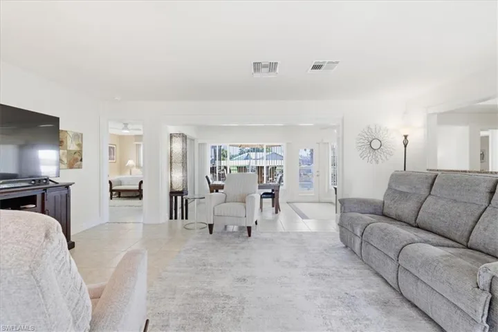 Living area featuring light tile patterned floors and baseboards