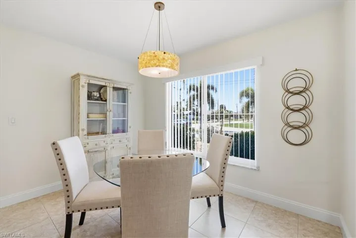 Dining space featuring light tile patterned flooring