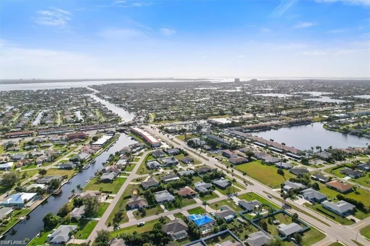 Aerial overview of property's location featuring nearby suburban area and a large body of water