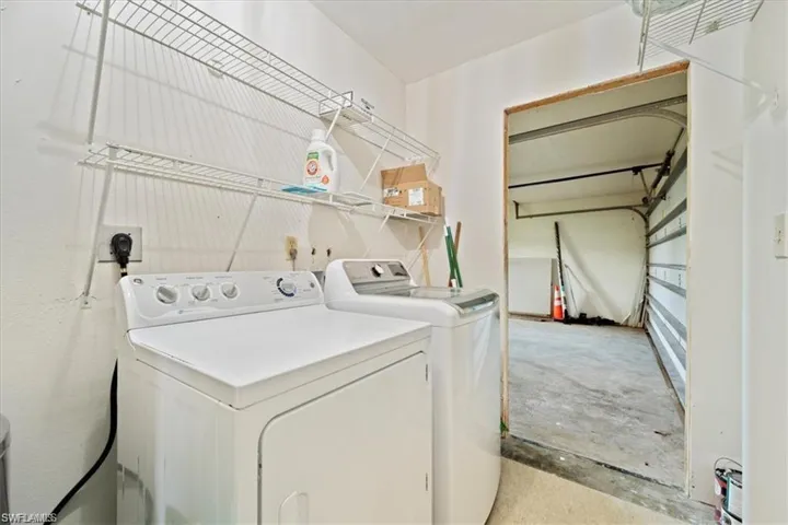 Clothes washing area featuring washing machine and clothes dryer