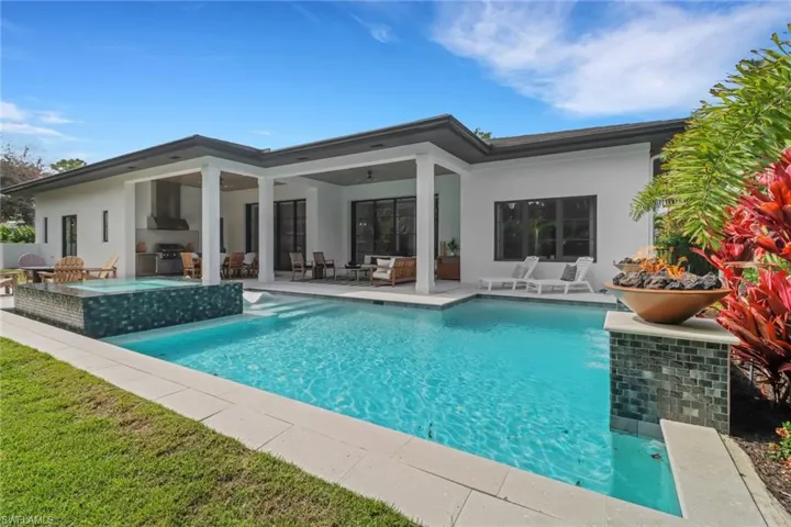 View of swimming pool with ceiling fan, grilling area, a patio area, and an outdoor hangout area