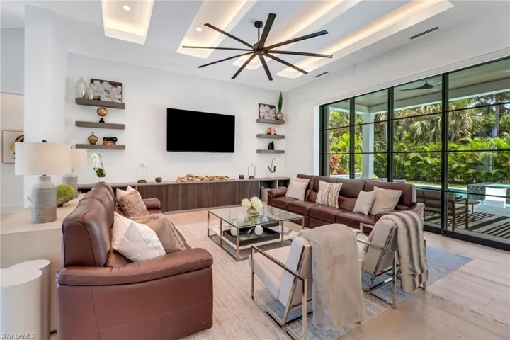 Living room with light hardwood / wood-style flooring and ceiling fan
