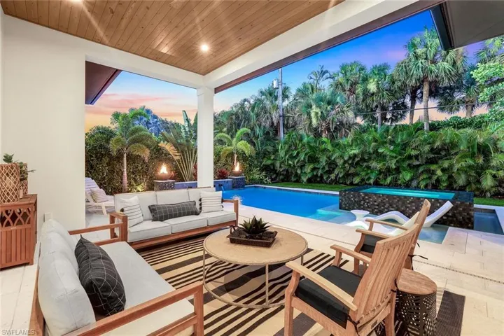 Swimming pool with a patio and an outdoor living space