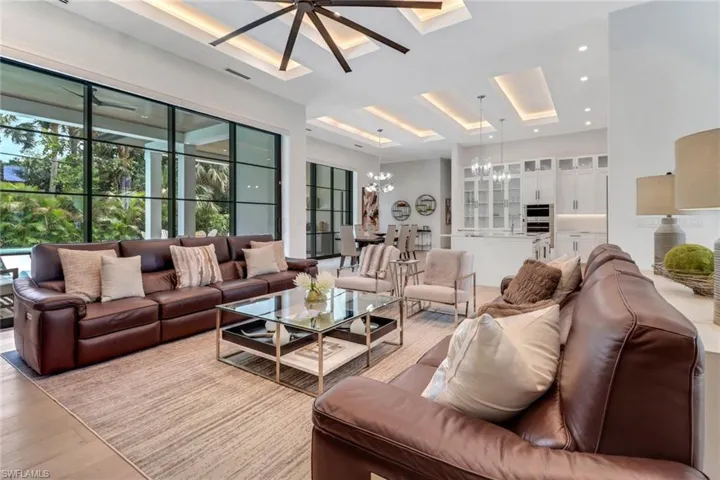 Living room with light hardwood / wood-style floors and an inviting chandelier