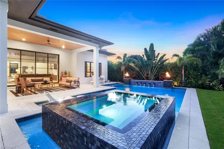 View of swimming pool with a patio, a pool with connected hot tub, a ceiling fan, and outdoor lounge area