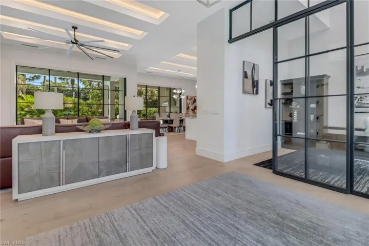 Living room with a chandelier and light hardwood / wood-style floors