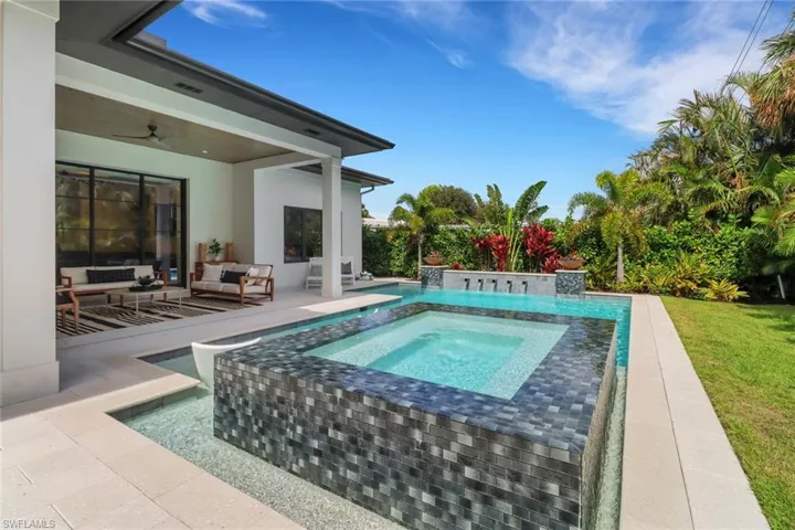 View of pool with a patio, outdoor lounge area, an in ground hot tub, and ceiling fan