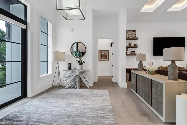Hallway featuring light hardwood / wood-style floors and a skylight