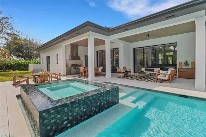View of swimming pool featuring an in ground hot tub, ceiling fan, a patio, and outdoor lounge area