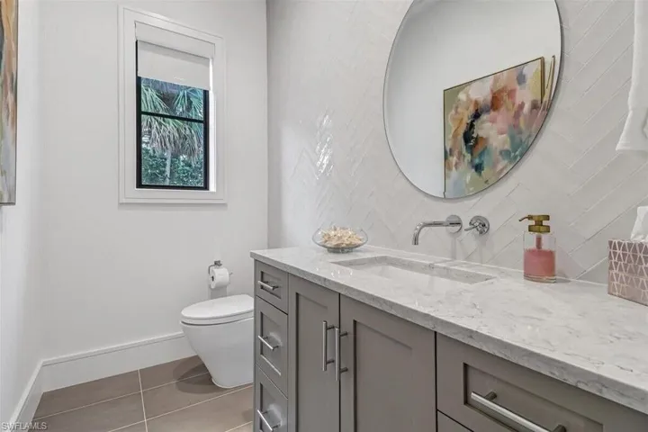 Bathroom featuring vanity, toilet, and tile patterned flooring