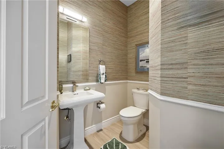 Bathroom featuring wood-type flooring and toilet