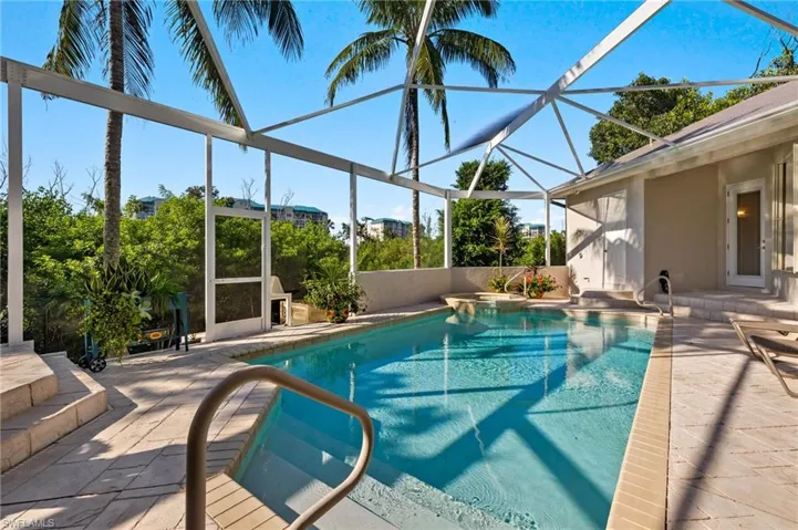 View of pool with a lanai and a patio