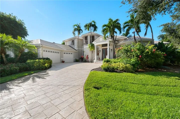 View of front of house featuring a front lawn and a garage