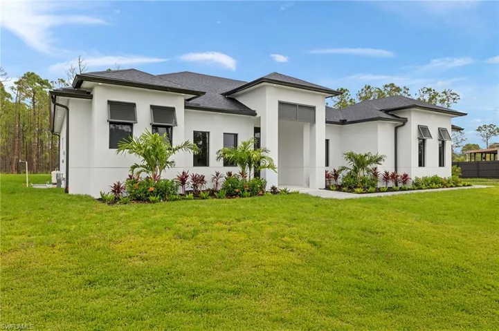 Prairie-style house featuring a front yard and stucco siding