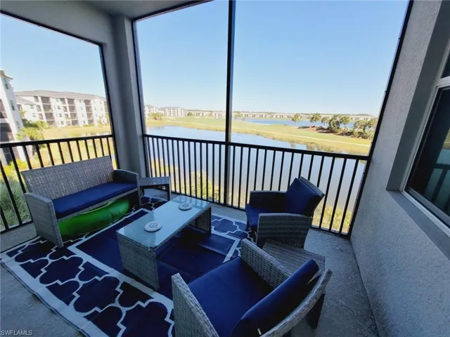 Sunroom with a water view and a healthy amount of sunlight